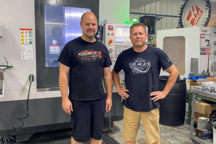 (L to R) Andy Sawyer and Dimey Eddinger, owners of DME Racing, with their HAAS 5-axis machine which they use to create custom parts they design in-house.